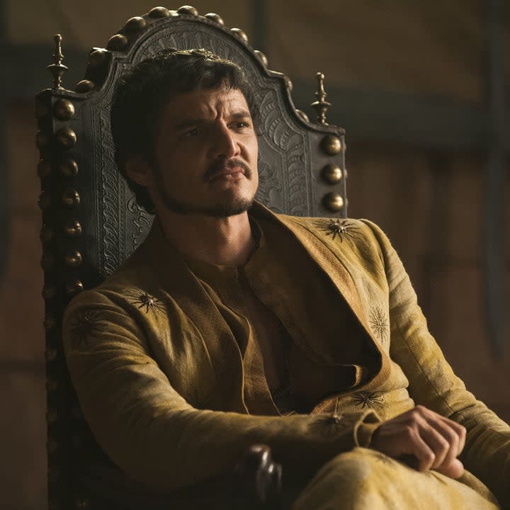 Pedro Pascal sits in a chair