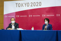 Tokyo 2020 CEO Toshiro Muto, left, and President Seiko Hashimoto attend the news conference after receiving a report from a group of infectious disease experts on Friday, June 18, 2021, in Tokyo. The experts including Shigeru Omi, head of a government coronavirus advisory panel, issued a report listing the risks of allowing the spectators and the measurements to prevent the event from triggering a coronavirus spread. (Yuichi Yamazaki/Pool Photo via AP)