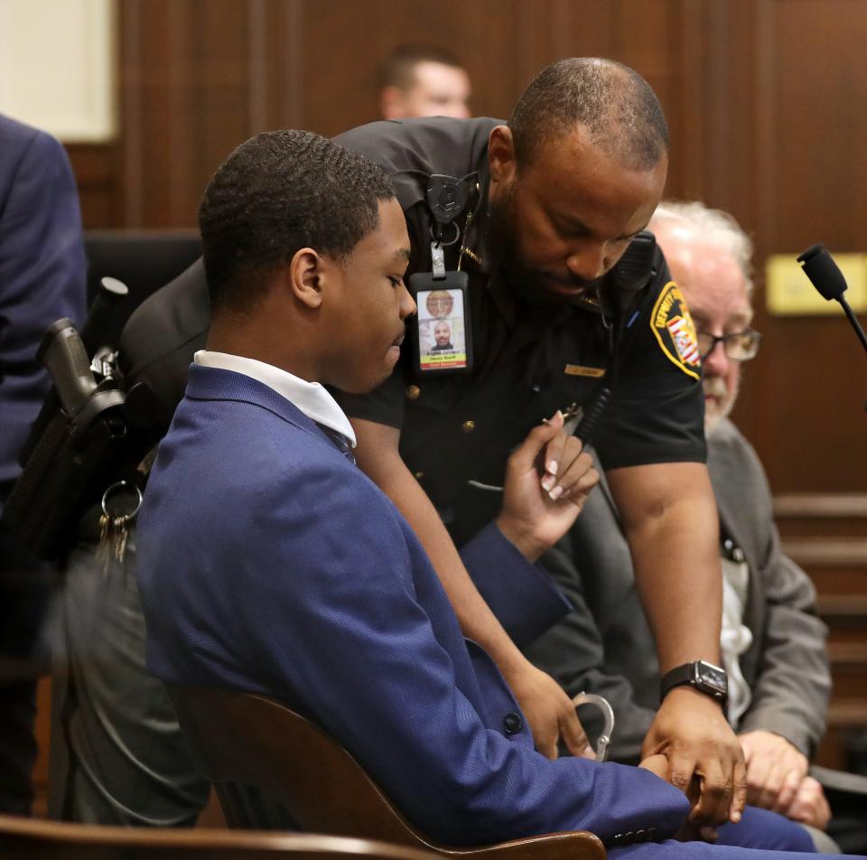 Defendant Christopher Blue is handcuffed by a Summit County Sheriff's deputy after the jury found him guilty of murder July 17 at the Summit County Courthouse in Akron.