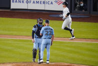 Toronto Blue Jays pitcher Chase Anderson talks to catcher Danny Jansen as New York Yankees' Brett Gardner runs the bases after hitting a two-run home run during the fourth inning of a baseball game Thursday, Sept. 17, 2020, in New York. (AP Photo/Frank Franklin II)