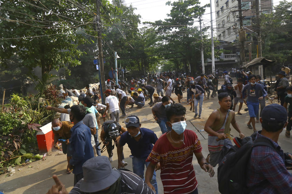 Anti-coup protesters disperse as the protesters confront police in Yangon, Myanmar Sunday, March 28, 2021. Protesters in Myanmar returned to the streets Sunday to press their demands for a return to democracy, just a day after security forces killed more than 100 people in the bloodiest day since last month's military coup. (AP Photo)