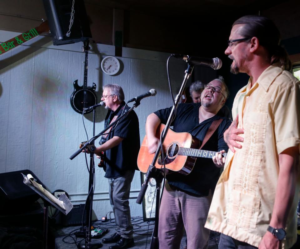 Musician Will Rideoutt performs the song "Johnny Come Back" by the late Rob Klajda Sunday, April 30, 2017, with Jerry Lew Patterson, left, Andy Wilson, right, and other former bandmates at the Green Door in Lansing during a show honoring Klajda's life.  Rob was a long-time fixture in the Michigan music scene and died from a heart attack April 1, 2017, while unloading gear for a gig in East Lansing.  Hundreds attended the show, and over $4,000 was raised to help Klajda's fiance Renee and daughter Veronica with both short and long-term expenses.
