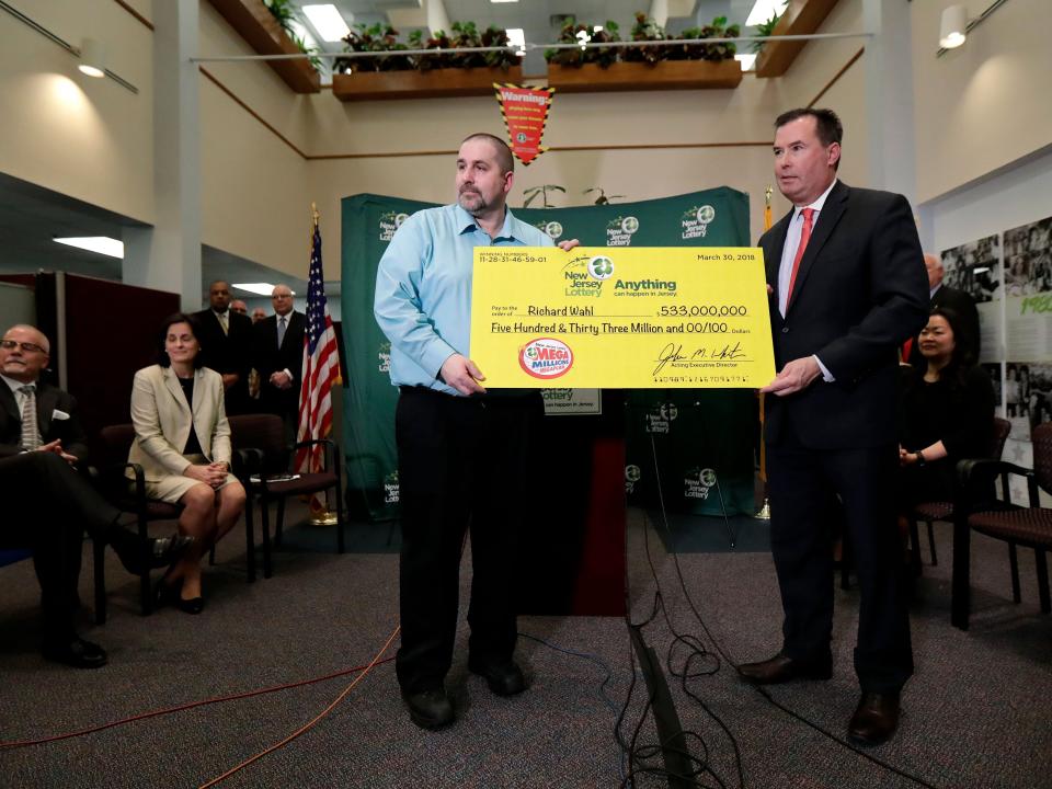 Richard Wahl, left, poses for photos with John White, New Jersey Lottery Acting Executive Director, during a news conference introducing Wahl as the $533 million Mega Millions jackpot winner at the New Jersey Lottery headquarters, Friday, April 13, 2018