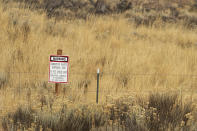 FILE - A warning sign points out the presence of asbestos at the North Ridge Estates superfund site just outside Klamath Falls, Ore., Nov. 19, 2015. The EPA has finalized a long-delayed ban on asbestos, a carcinogen that kills tens of thousands of Americans every year. (Kevin N. Hume/The Herald And News via AP)