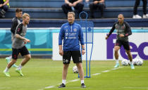 Denmark's manager Kasper Hjulmand, center, leads a training session of Denmark's national team in Helsingor, Denmark, Monday, June 14, 2021. It is the first training of the Danish team since the Euro championship soccer match against Finland when Christian Eriksen collapsed last Saturday. (AP Photo/Martin Meissner)