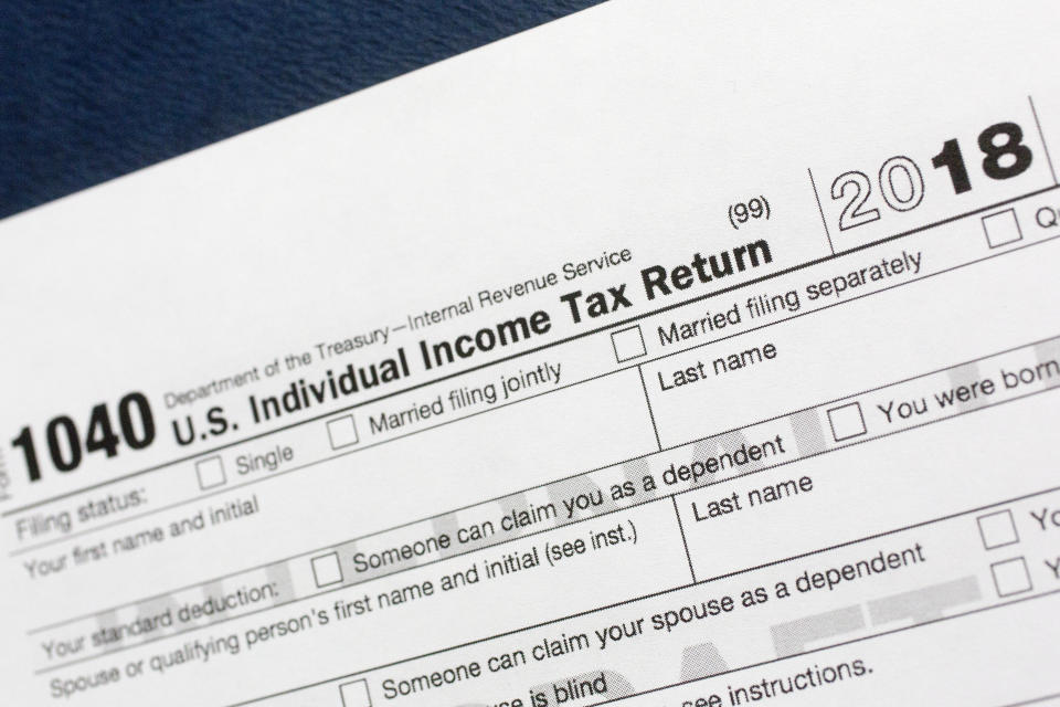 FILE- This July 24, 2018, file photo shows a portion of the 1040 U.S. Individual Income Tax Return form for 2018 in New York. The $1.5-trillion tax overhaul includes the end of a 75-year-old deduction on alimony payments. It may seem too early to start thinking about your tax return, but procrastination could cost you thousands of dollars. (AP Photo/Mark Lennihan, File)