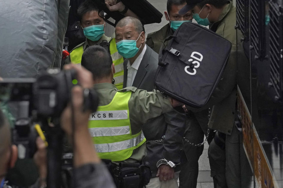 FILE - In this Tuesday, Feb. 9, 2021 file photo, Democracy advocate Jimmy Lai, center, arrives at Hong Kong's Court of Final Appeal in Hong Kong. The coronavirus pandemic has upended life around the globe, but it has hasn’t stopped the spread of authoritarianism and extremism. Some researchers believe it may even have accelerated it, but curbing individual freedoms and boosting the reach of the state. Since COVID-19 hit, Hungary has banned children from being told about homosexuality. China shut Hong Kong’s last pro-democracy newspaper. Brazil’s president has extolled dictatorship. Belarus has hijacked a passenger plane. A Cambodian human rights lawyer calls the pandemic “a dictator's dream opportunity.” But there are also resistance movements, as protesters from Hungary to Brazil take to the streets to defend democracy. (AP Photo/Kin Cheung, File)