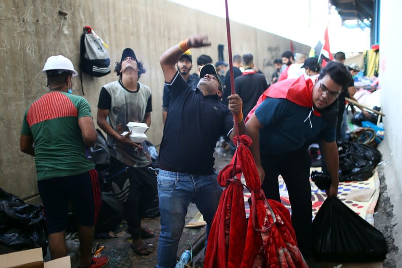 Iraqi demonstrators use blanket to supply food for their fellows inside the high-rise building, called by Iraqi the Turkish Restaurant Building,, during anti-government protests in Baghdad