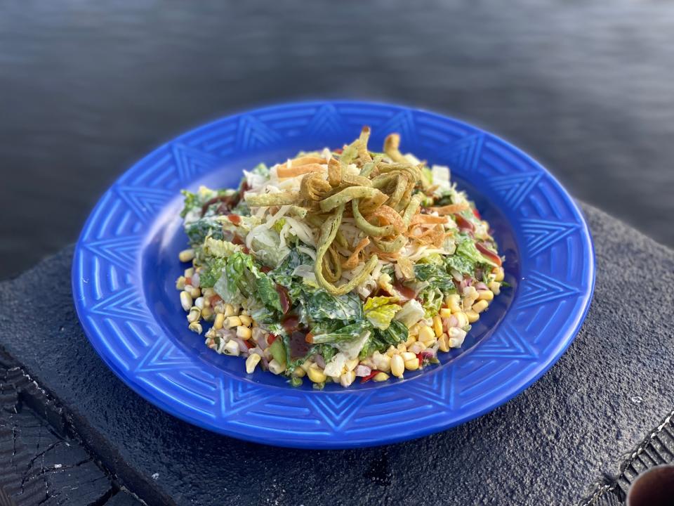 Del Fuego's Santa Fe Caesar salad features romaine, corn salsa, creamy caesar, chihuahua cheese, tortilla chips, honey-chipotle BBQ drizzle.