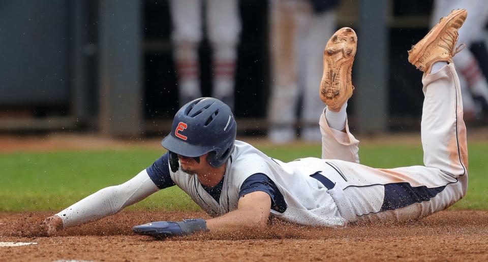 Ellet base-runner Trenton Fink scores during the fifth inning of the City Series baseball championship against Firestone at Canal Park on Wednesday. Ellet won 3-2.