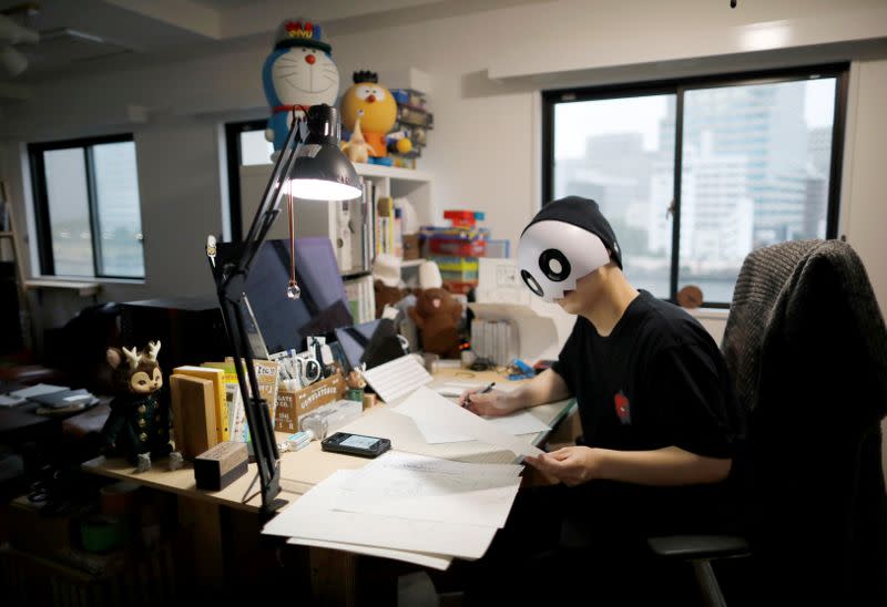 Japanese manga artist Kamentotsu draws his four-panel strip comic 'Koguma's Cake Shop' in Tokyo