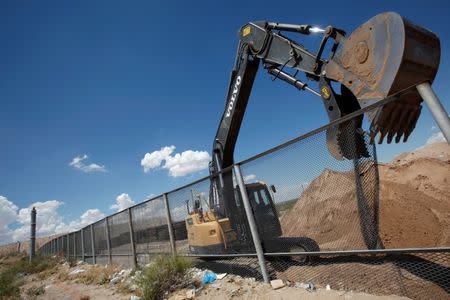 File Photo: An excavator removes a fence, which will be replaced by a section of the U.S.-Mexico border wall at Sunland Park, U.S. opposite the Mexican border city of Ciudad Juarez, Mexico, August 26, 2016. REUTERS/Jose Luis Gonzalez/File Photo