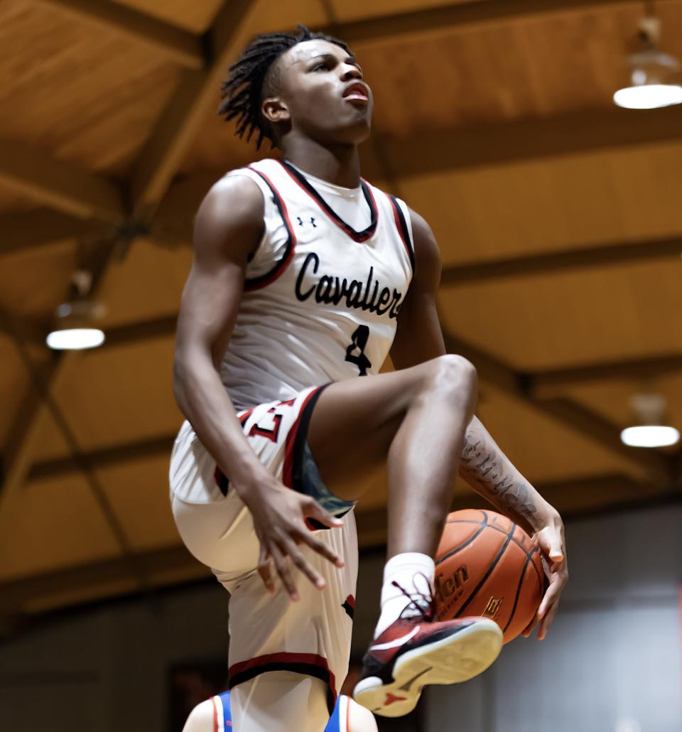 Lake Travis forward Jayden Thomas attempts an acrobatic shot after a referee's whistle during the Tigers' Jan. 16 game against Westlake. Thomas averaged 13.5 points and 4.6 rebounds this season for the District 26-6A champions.