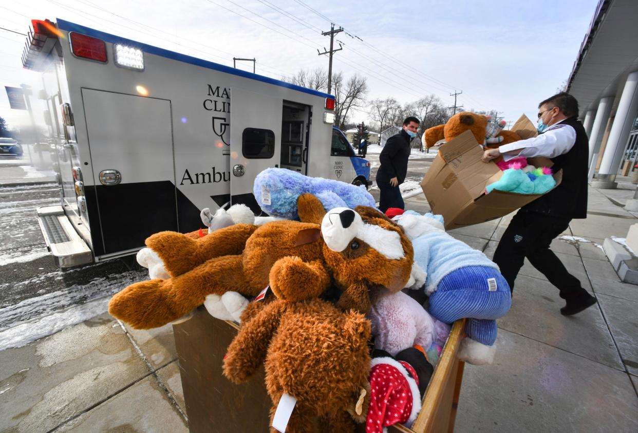 St. Cloud State and Mayo Clinic Ambulance workers load dozens of donated teddy bears into an ambulance Wednesday, Dec. 8, 2021, at the Herb Brooks National Hockey Center in St. Cloud. The bears were collected from fans during the Teddy Bear Toss in the first intermission of Saturday's hockey game. They were transported to Catholic Charities for use in the Toys for Tots program. 