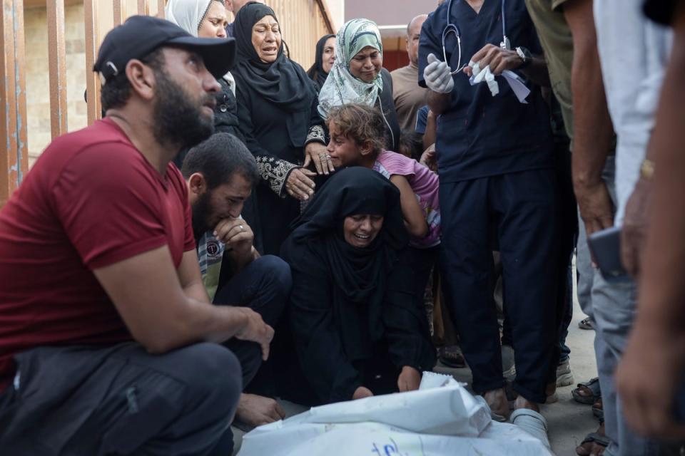 Palestinians mourn their relatives killed in an Israeli strike in Mawasi (Anadolu via Getty)