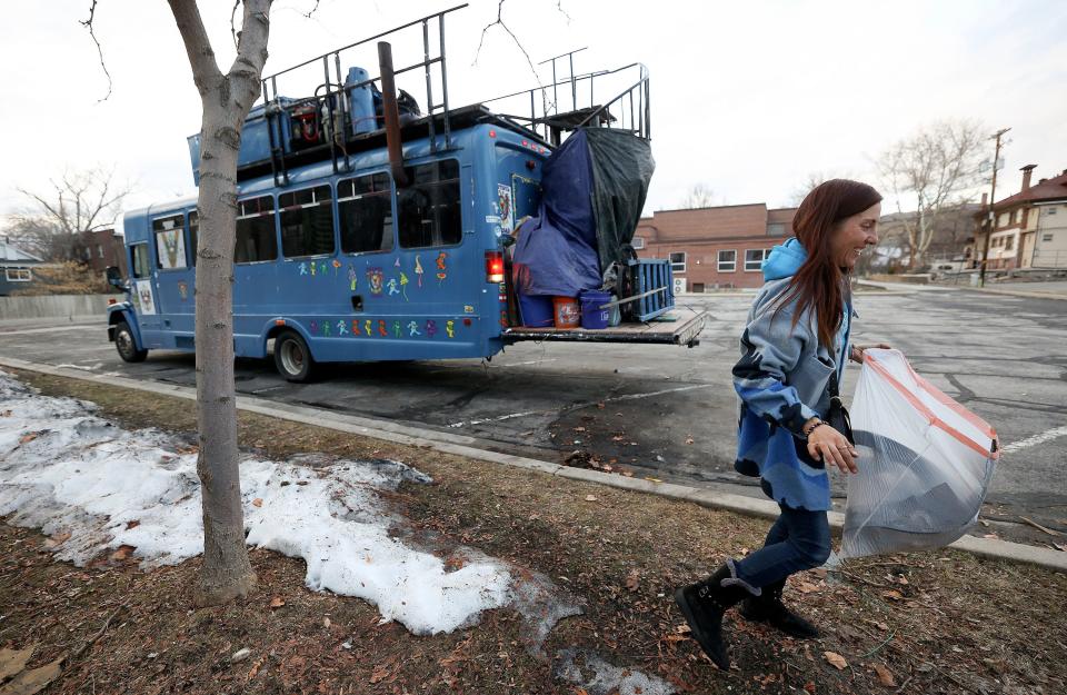 Kseniya Kniazeva, Nomad Alliance founder, does a final sweep, picking up trash before the Nomad Alliance bus leaves a parking lot.