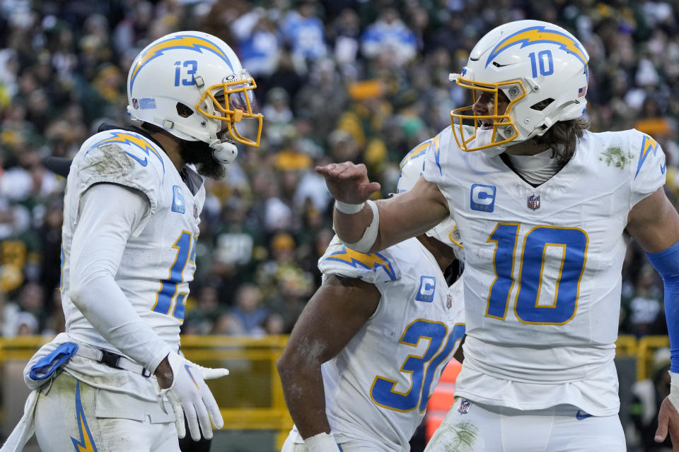 Los Angeles Chargers wide receiver Keenan Allen, left, and quarterback Justin Herbert (10) react after connecting on a touchdown pass against the Green Bay Packers during the second half of an NFL football game, Sunday, Nov. 19, 2023, in Green Bay, Wis. (AP Photo/Morry Gash)