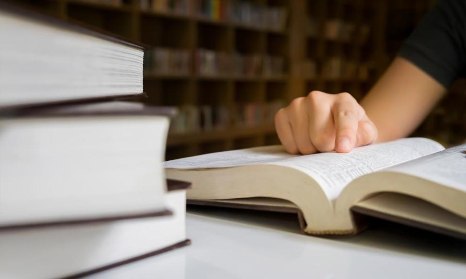 A woman reading a book in a library