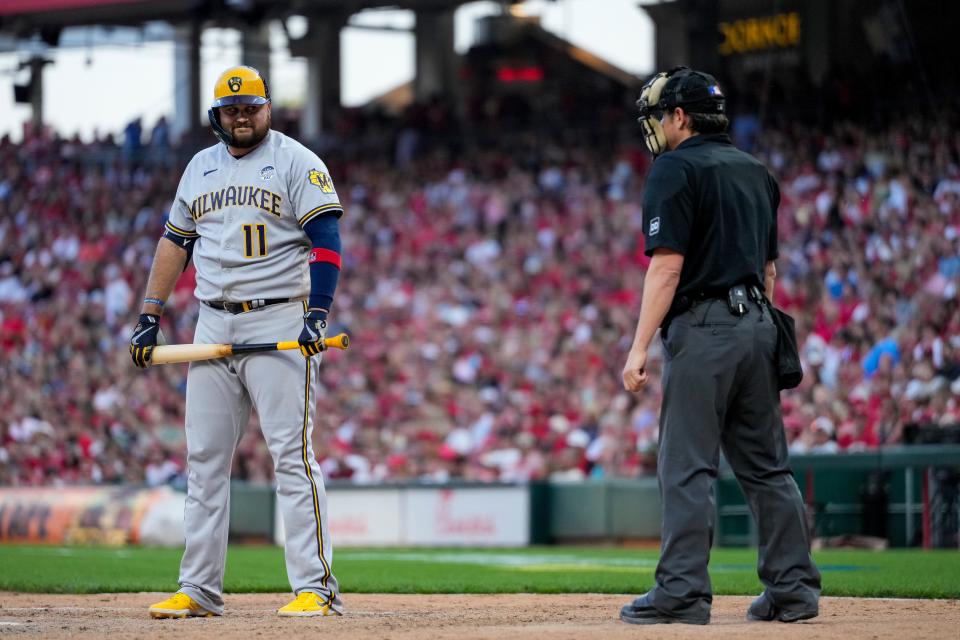 Brewers first baseman Rowdy Tellez reacts to home plate umpire DJ Reyburn after a called third strike in the 10th inning during a game against the Cincinnati Reds on June 2, 2023.