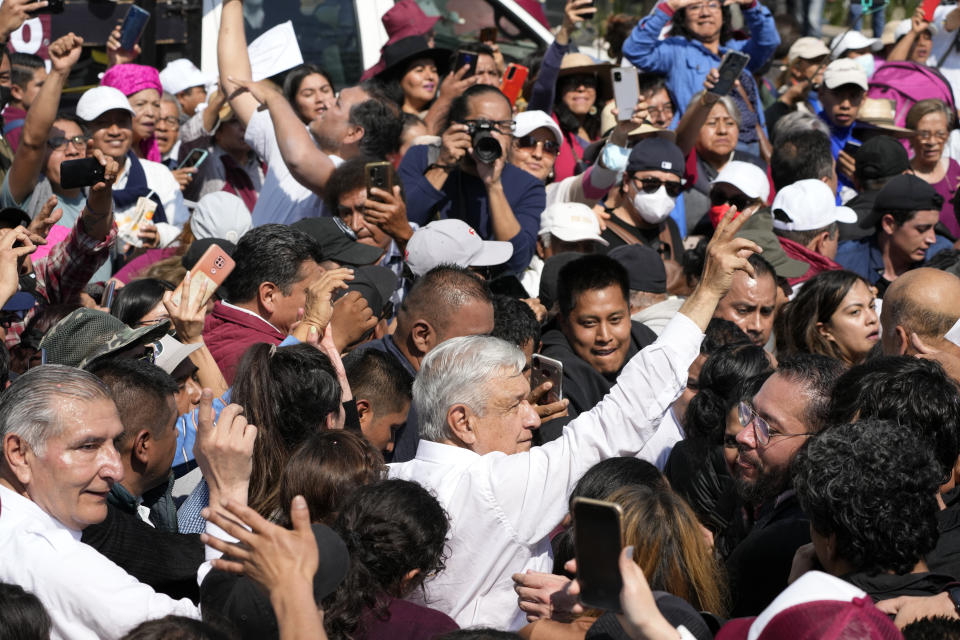 Mexican President Andrés Manuel Lopez Obrador greets supporters during a march to support his administration, in Mexico City, Sunday, Nov. 27, 2022. (AP Photo/Fernando Llano)