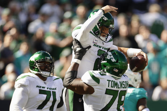 New York Jets running back Michael Carter (32) warms up before taking on  the Miami Dolphins during an NFL football game Sunday, Oct. 9, 2022, in  East Rutherford, N.J. (AP Photo/Adam Hunger