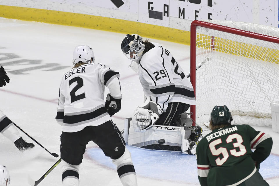 Los Angeles Kings goalie Pheonix Copley (29) blocks a shot as defenseman Alexander Edler and Minnesota Wild left wing Adam Beckman look on during the third period of an NHL hockey game Tuesday, Feb. 21, 2023, in St. Paul, Minn. Minnesota won 2-1. (AP Photo/Craig Lassig)