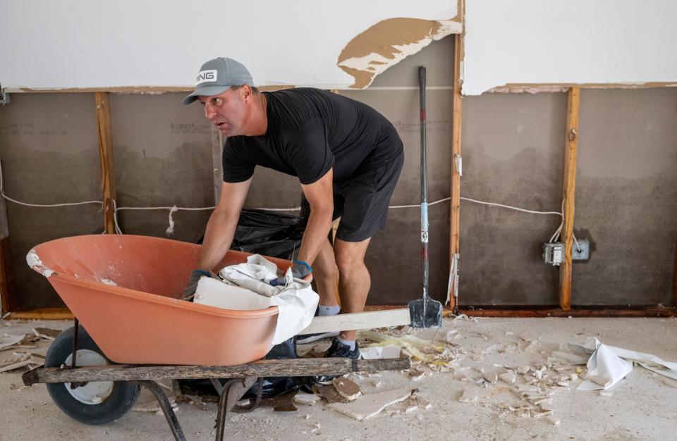 Chadd Kodak helps clean out a house that suffered from storm surge caused by Hurricane Ian in Naples, FL, on Wednesday, October 5, 2022.