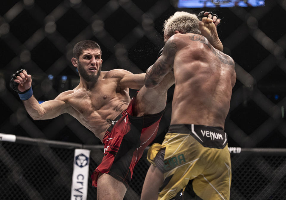 Oct 22, 2022; Abu Dhabi, UAE; Charles Oliveira (red gloves) and Islam Makhachev (blue gloves) during UFC 280 at Etihad Arena. Mandatory Credit: Craig Kidwell-USA TODAY Sports