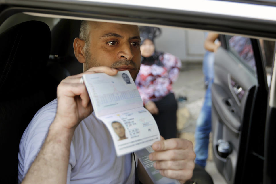 Australian-Lebanese dual citizen Amer Khayyat shows his Australian passport to journalists, after his release from prison in Roumieh, east of Beirut, Lebanon, Friday, Sept. 20, 2019. Lebanese authorities have released the Lebanese-Australian who had been detained in Lebanon for more than two years after he was found innocent in an alleged plot to bring down a passenger plane bound for the United Arab Emirates from Sydney. (AP Photo/Bilal Hussein)