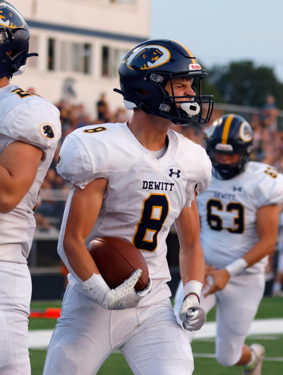 DeWitt's Bryce Kurncz celebrates his touchdown against East Lansing, Friday, Sept. 16, 2022, in East Lansing, Mich. East Lansing won 36-30.