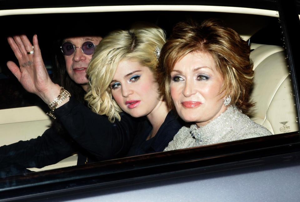 British rock singer Ozzy Osbourne (L) with daughter Kelly (C) and wife Sharon (R) arrive for a pre-World Cup party at the Herfordshire home of David and Victoria Beckham in southern England May 21, 2006. REUTERS/Luke MacGregor