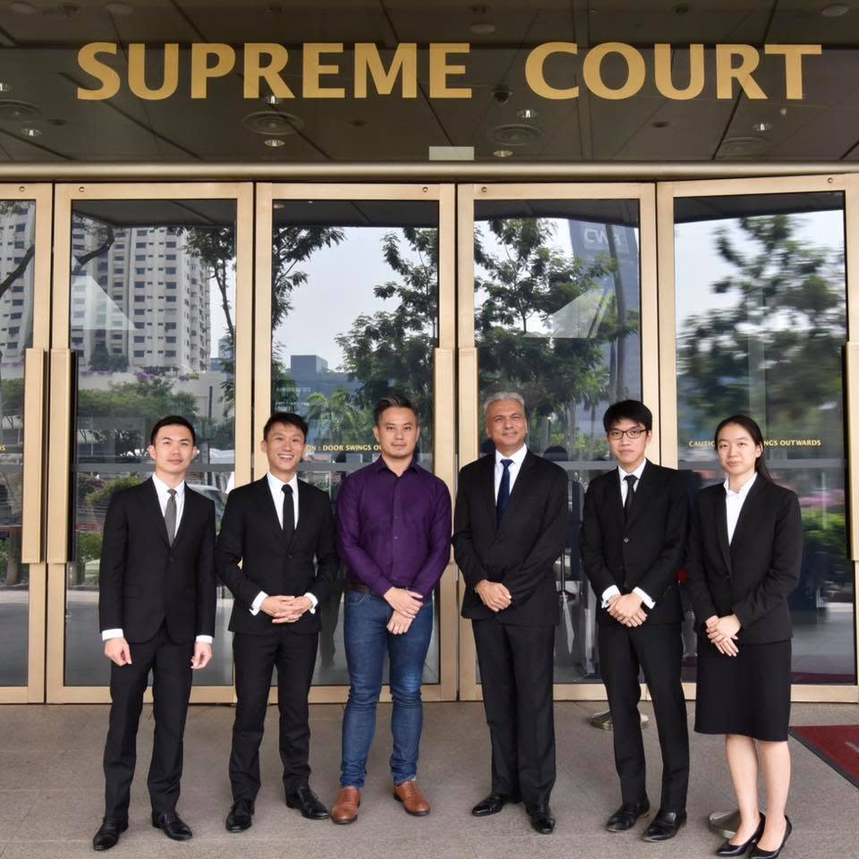 Bryan Choong Chee Hoong, a former executive director of non-profit LGBTQ social support group Oogachaga, with his lawyers.