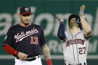 Houston Astros' Jose Altuve, right, celebrates next to Washington Nationals second baseman Asdrubal Cabrera after a double during the fifth inning of Game 3 of the baseball World Series Friday, Oct. 25, 2019, in Washington. (AP Photo/Patrick Semansky)