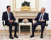 Russian President Vladimir Putin, right, listens to Syrian President Bashar Assad during their meeting in the Kremlin in Moscow, Russia, Monday, Sept. 13, 2021. (Mikhail Klimentyev, Sputnik, Kremlin Pool Photo via AP)