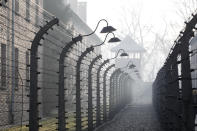 People arrive for commemorations at the Auschwitz Nazi death camp in Oswiecim, Poland, Monday, Jan. 27, 2020. Survivors of the Auschwitz-Birkenau death camp gathered for commemorations marking the 75th anniversary of the Soviet army's liberation of the camp, using the testimony of survivors to warn about the signs of rising anti-Semitism and hatred in the world today.(AP Photo/Czarek Sokolowski)