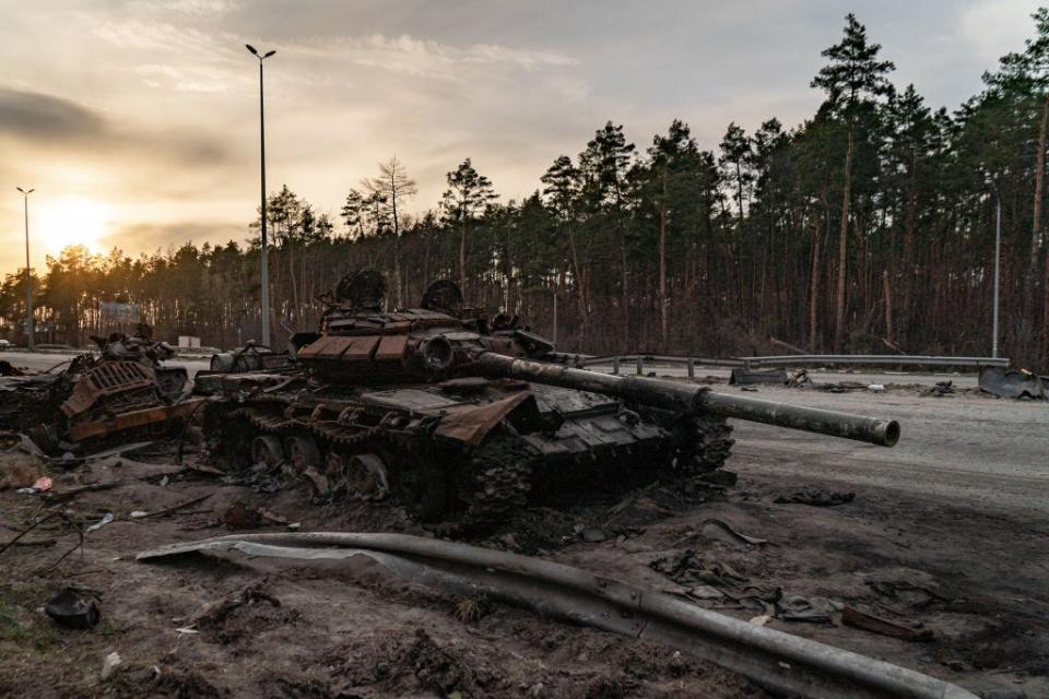 A destroyed Russian tank along the side of the road in Ukraine.