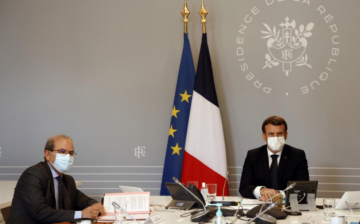 Mohammed Moussaoui, president of the French Council of the Muslim Faith (L) signs the "Charter of principles" next to French President Emmanuel Macron (R) - POOL/REUTERS 