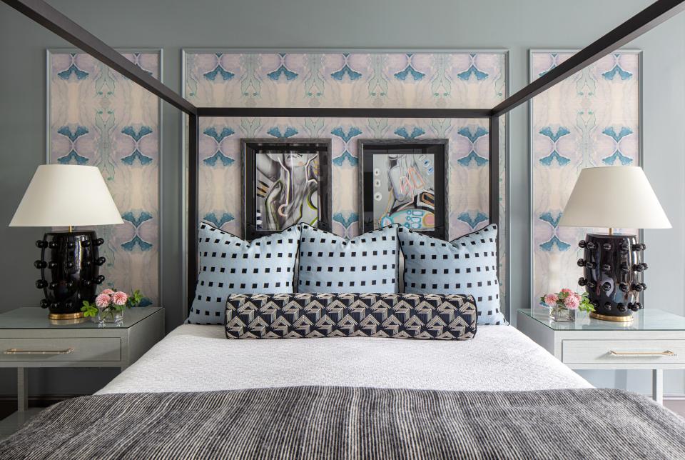 Walls coated in a soothing Benjamin Moore Gibraltar Cliffs pair well with Lindsay’s blue and purple Caribbean Grasscloth wall covering. “The wallpaper over the bed is the same color as the walls, but just a little touch of pattern,” Jill says. The painted photographs are by artist Allison Hobbs. The Room & Board Architecture Bed is topped with Kelly Wearstler blue pillows, a black-and-white Schumacher bolster, and a Rebecca Atwood blanket. Custom nightstands are topped with Kelly Wearstler lamps.