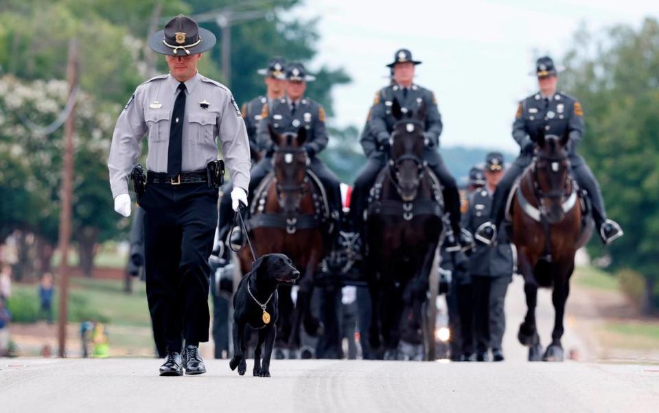 Slain Wake County Sheriffís Deputy Ned Byrdís K9 partner, Sasha, leads the N.C. State Highway Patrolís Caisson Unit during a procession for Deputy Byrd before his funeral at Providence Baptist Church in Raleigh, N.C., Friday, August 19, 2022.