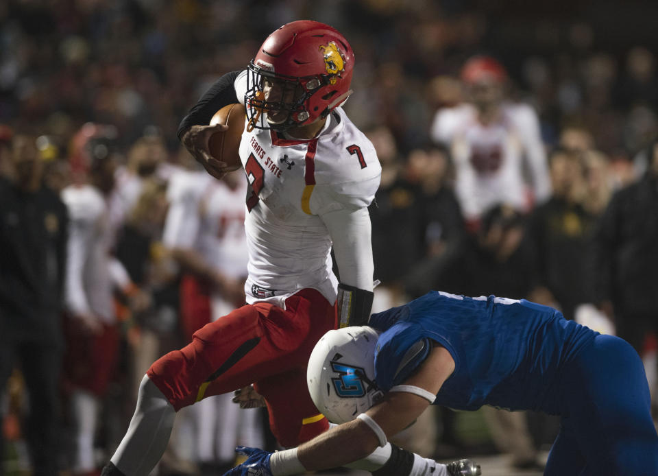 In this Oct. 13, 2018, photo, Ferris State quarterback Jayru Campbell (7) runs the ball as Grand Valley State linebacker Brendan McMahon (3) tackles him during an NCAA college football game in Grand Rapids, Mich. Ferris State defeated Grand Valley State 35-31. Campbell, who has led the Bulldogs to the national championship game, highlights The Associated Press Division II All-America team along with two of his teammates. Campbell, a junior, has passed for 2,832 and 26 touchdowns and run for 1,338 and 20 scores, leading Ferris State to a 15-0 record heading into the D-II championship game against Valdosta State on Saturday. (Alyssa Keown/The Grand Rapids Press via AP)