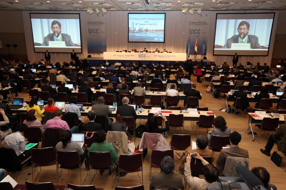 The chair of the Intergovernmental Panel on Climate Change (IPCC) Rajendra K. Pachauri, second from right, delivers an opening remarks during the opening session of the 10th Plenary of (IPCC) Working Group II and the 38th Session of the IPCC in Yokohama, near Tokyo Tuesday, March 25, 2014. The hundreds of scientists from 100 countries meeting in this Japanese port city are putting finishing touches on a massive report emphasizing the gravity of the threat the changing climate poses for communities from the polar regions to the tropics. (AP Photo/Eugene Hoshiko)