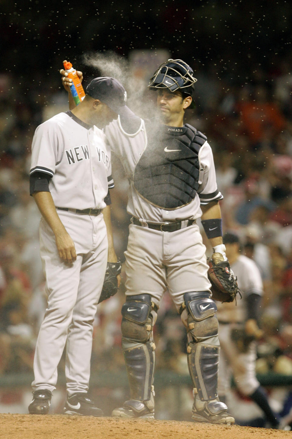 FILE - New York Yankees catcher Jorge Posada, right, applies bug spray to relief pitcher Mariano Rivera before the bottom of the ninth inning in Game 2 of an American League Division Series baseball game against the Cleveland Indians, in Cleveland, Oct. 5, 2007. Their fans still bugged by what happened in 2007, the New York Yankees could face those pesky midges again when the American League Division Series returns to Cleveland this weekend. (AP Photo/Amy Sancetta, file)