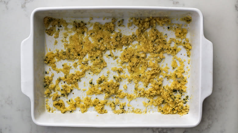 butter and seasoning in baking dish