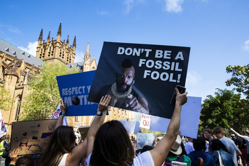 A protestor carries a "Mr. T" sign in Sydney
