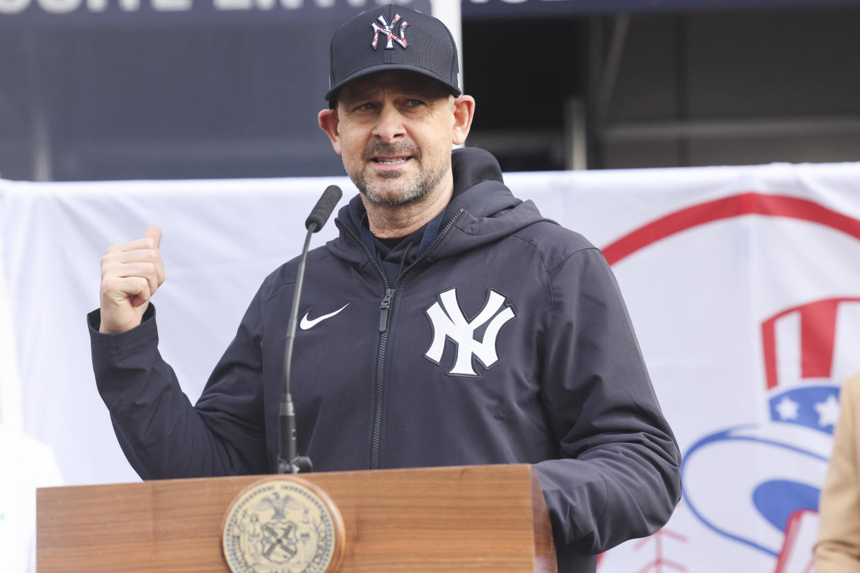 Aaron Boone, manager of the New York Yankees, speaks during a news conference outside a COVID-19 vaccination hub inside Yankee Stadium in the Bronx borough of New York on Friday, February 5, 2021. / Credit: Angus Mordant/Bloomberg via Getty Images
