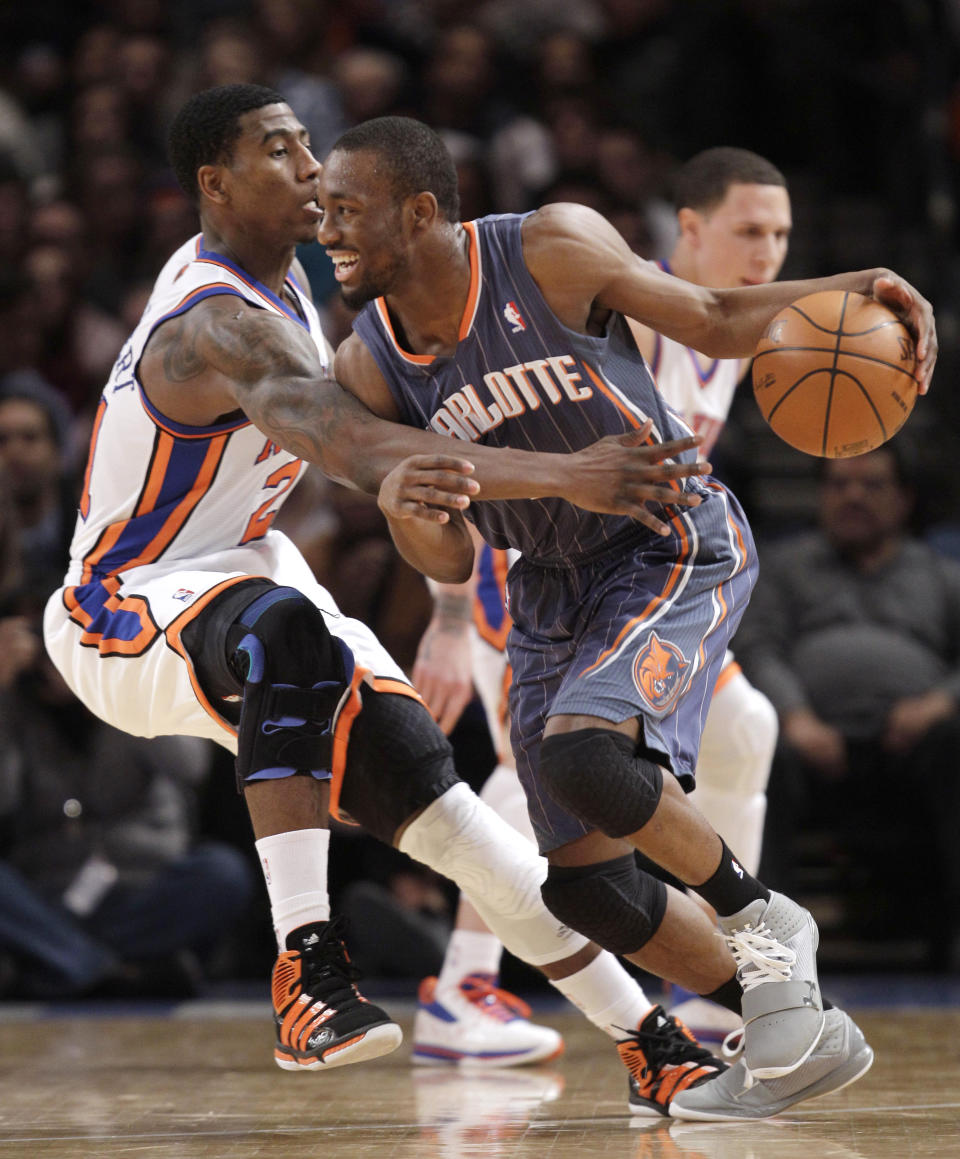 FILE - New York Knicks guard Iman Shumpert (21) defends Charlotte Hornets' Kemba Walker in the fourth quarter of the Knicks' 91-87 victory in an NBA basketball game at Madison Square Garden in New York, in this Monday, Jan. 9, 2012, file photo. The New York Knicks have been looking long for a point guard and didn't have to search too far for their new one. Kemba Walker is from New York and is coming back to the Madison Square Garden court where he's had plenty of success already. (AP Photo/Kathy Willens, File)