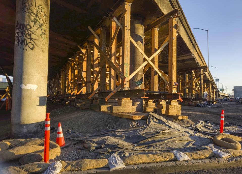 Structural supports hold the burned section of Interstate 10 in Los Angeles, Saturday, Dec. 9, 2023. (AP Photo/Damian Dovarganes)