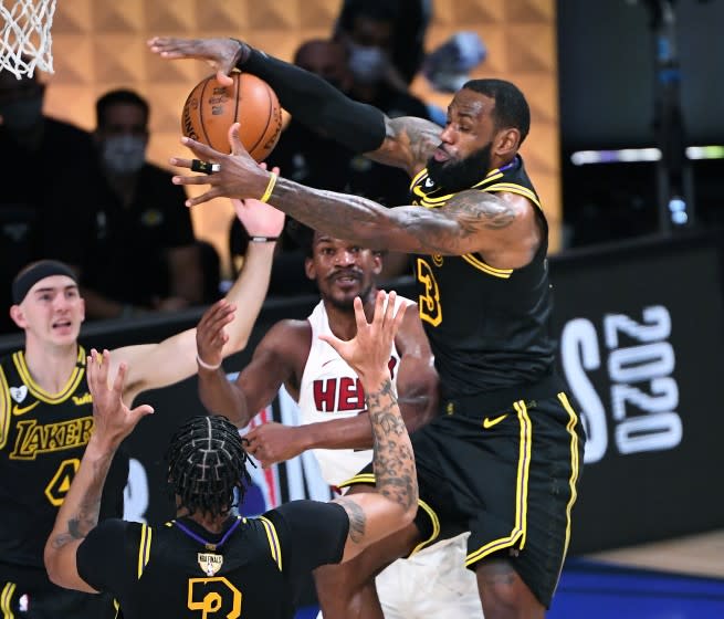 ORLANDO, FLORIDA OCTOBER 2, 2020-Lakers LeBron James steals the ball from Heat's Jimmy Butler.