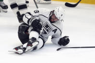 Los Angeles Kings defenseman Drew Doughty holds his knee as he lies on the ice during the second period of the team's NHL hockey game against the Dallas Stars on Friday, Oct. 22, 2021, in Dallas. (AP Photo/Richard W. Rodriguez)