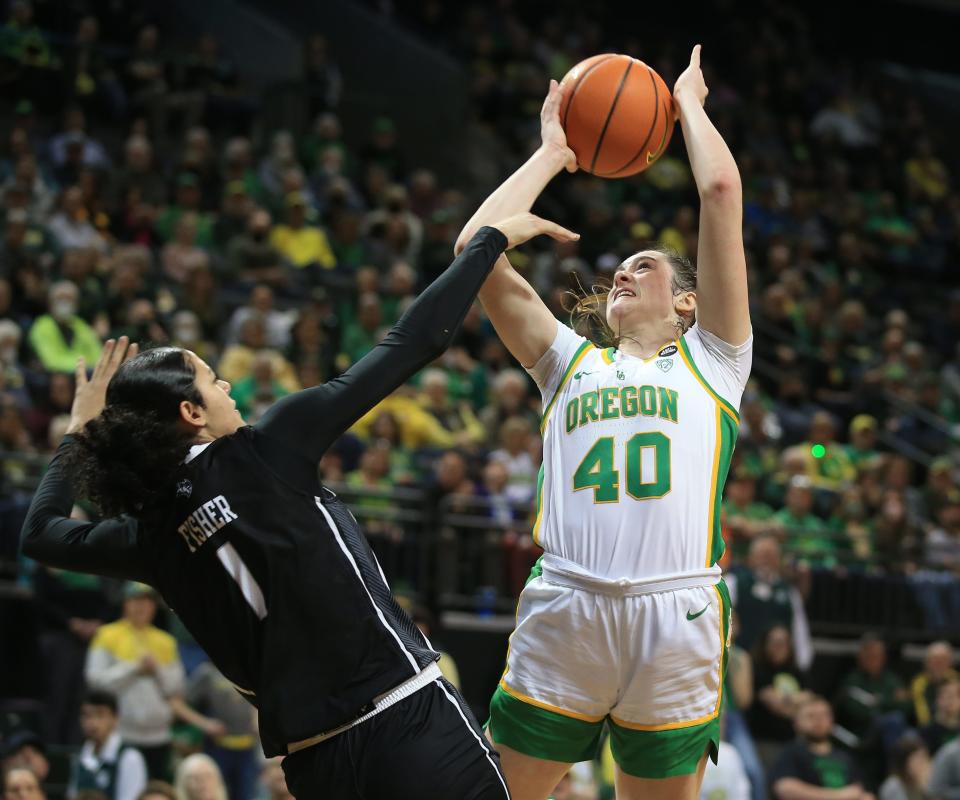 Oregon's Grace VanSlooten, right, shoots over Rice's Malia Fisher during the second half of the 2023 WNIT second round game in Eugene on March 20.